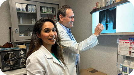 Dr. Zappan and Dr. Hasan at an x-ray viewer.